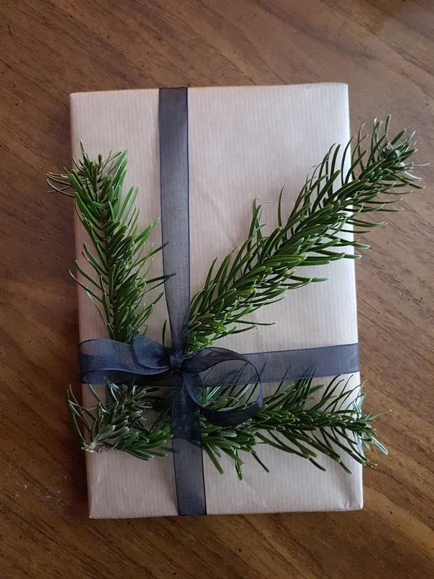 brown paper packaging with ribbon and green sprigs