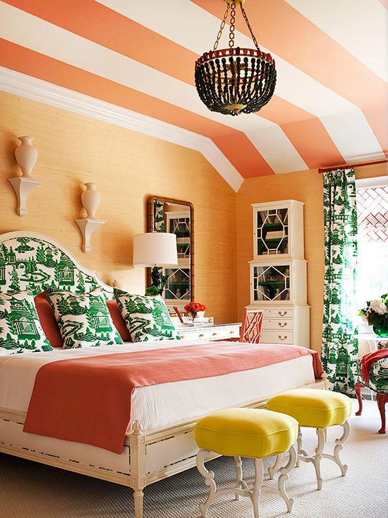 Striped orange ceiling imitates a tent like feel in this beautifully bright bedroom featured on bhg.com