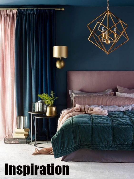 inspirational shot of a dark blue bedroom with gold and pink accents