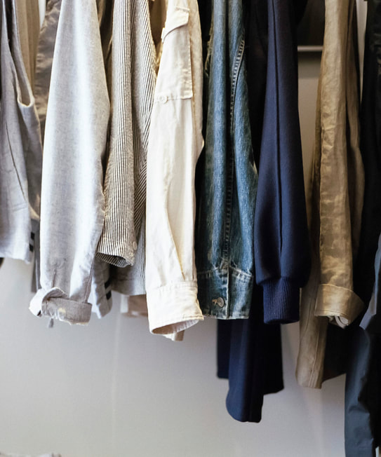 close up shot of some clothes neatly hung in a similar colour scheme. capsule wardrobe