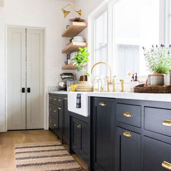 indigo blue kitchen by McGee and Co with pale walls and marble counter tops