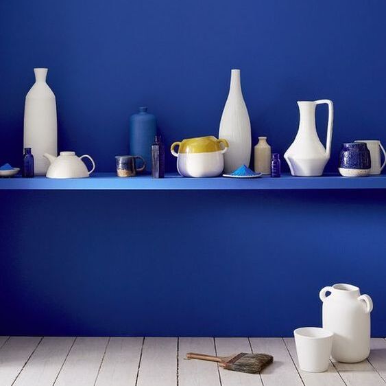 blue and white shelf with modern ceramics