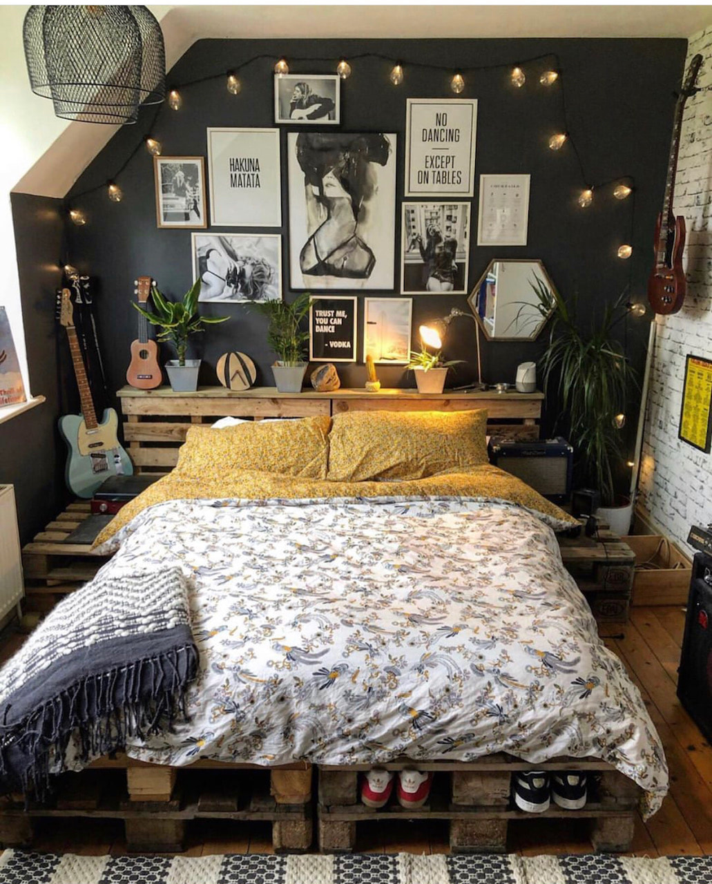 Maximalist eclecitc bedroom with reclaimed bed and black wall. 