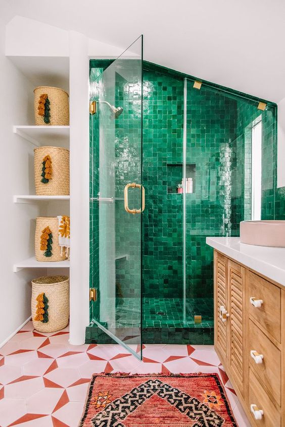 green pink and gold family bathroom by kelly mindell with pink patterned tiles on the floor and woven baskets on the shelves