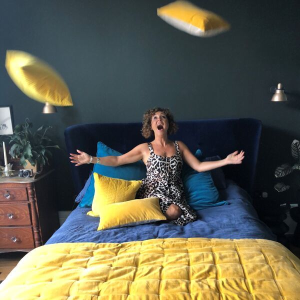 playing on the bed, amy wilson, yellow accessories, teal and blue bedding