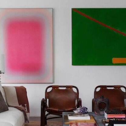 bold pink and green paintings in a neutral interior creating high contrast.