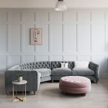 grey chesterfield curved L Shaped sofa with grey wall panelling