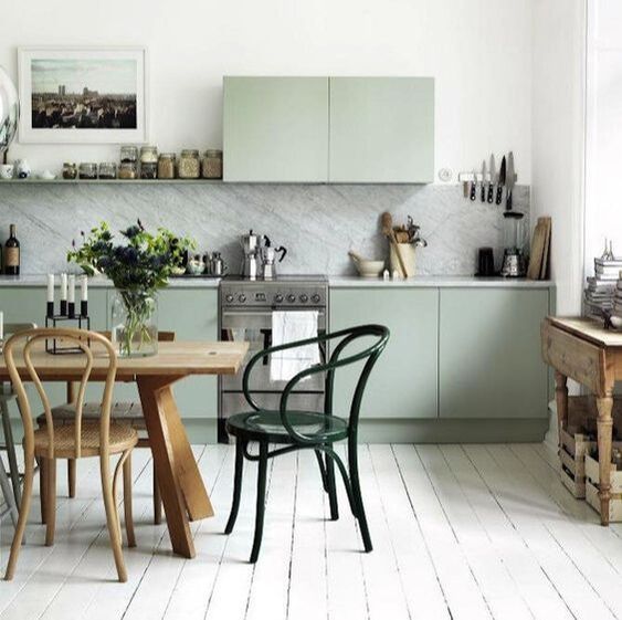 Pale green kitchen with marble work tops