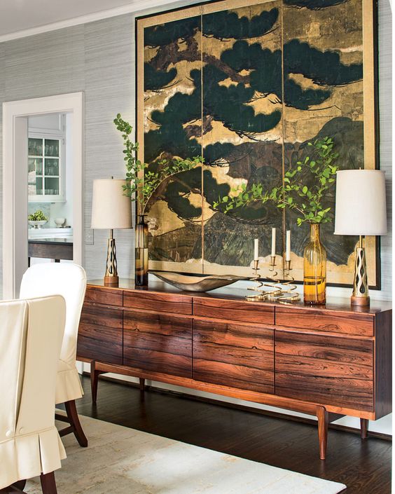 large scale japanese painting above a wooden sideboard. 