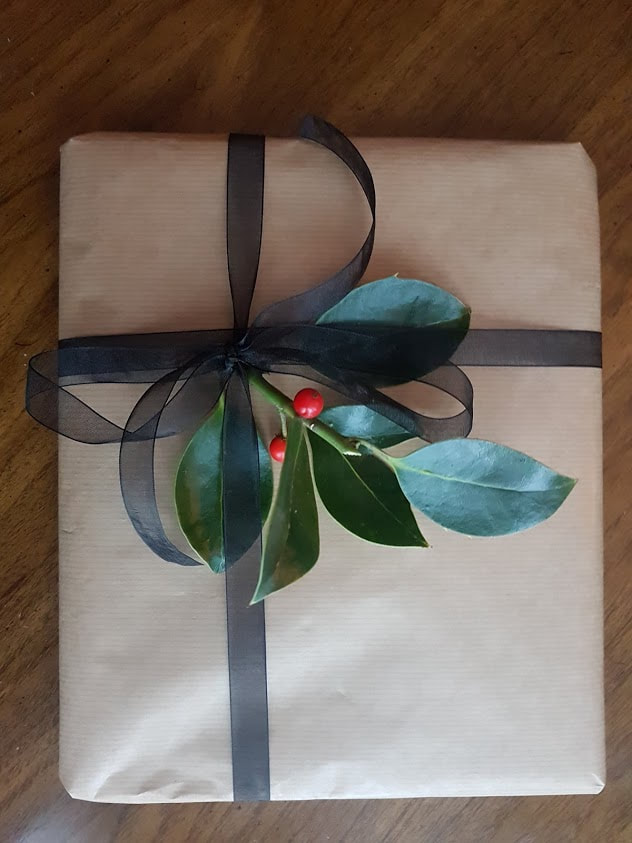 holly sprig with brown paper Christmas presents