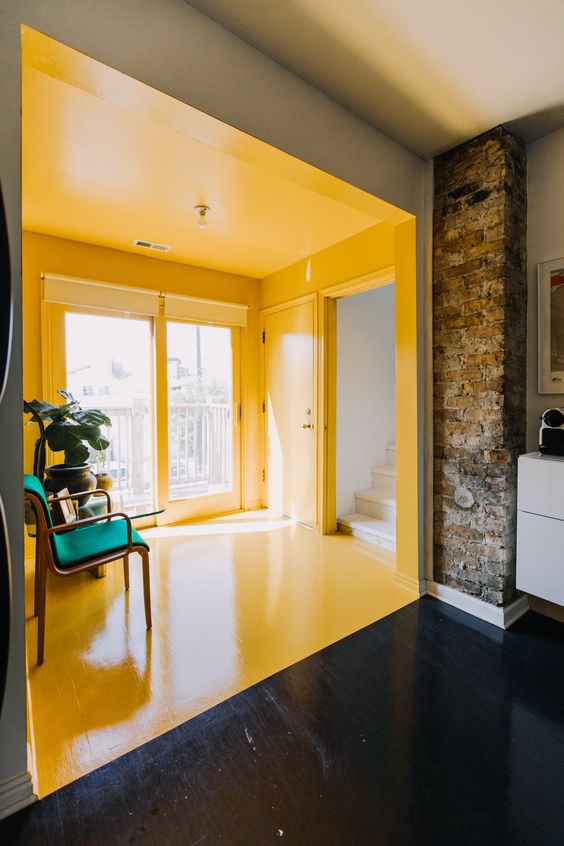The home of Tes Hash Davidson and her partner Daniel has a beautiful bright yellow SUNroom that links the kitchen and the guest room.