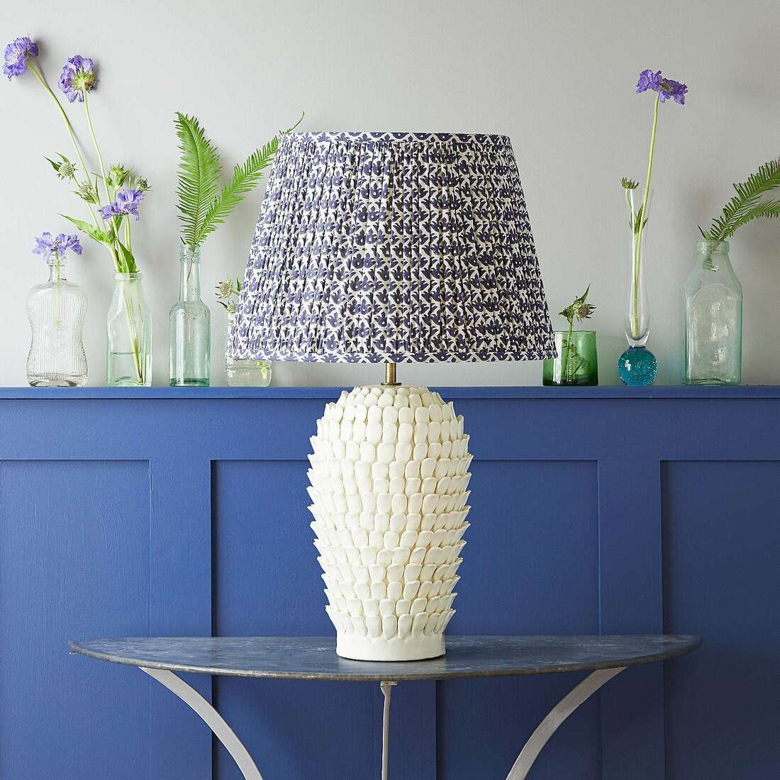 textured ceramic lamp with multiple petals in an off white by pooky lighting.