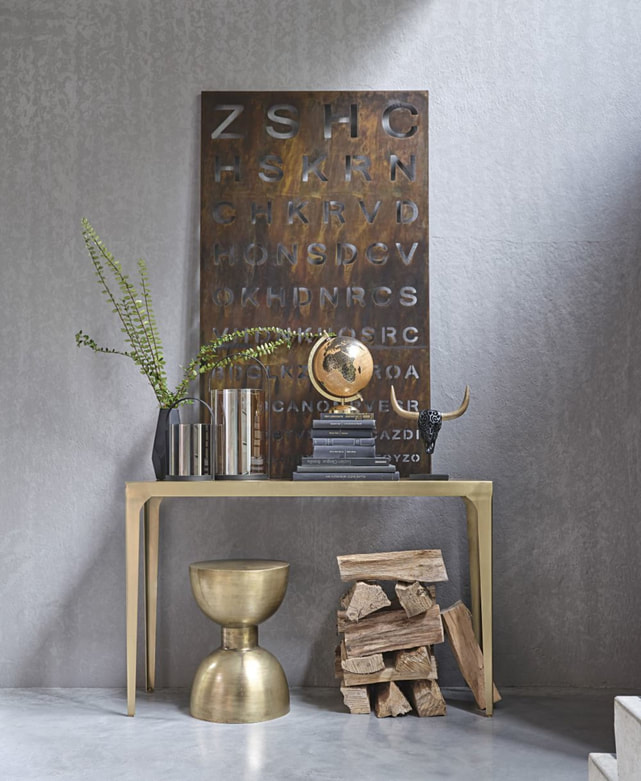 styled brass console table with wood and industrial elements