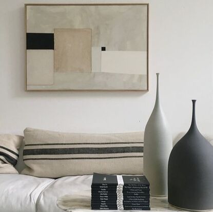 tonal low contrast art above a neutral sofa and interior