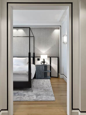 grey bedroom with dark four poster bed