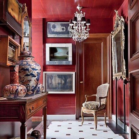 red hallway by john yunis filled with antiques