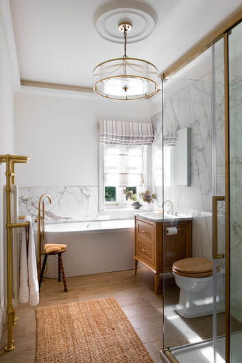 Primary bathroom with marble tiles and soaker tub
