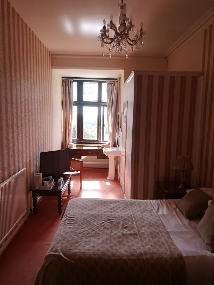 unrenovated dated hotel bedroom