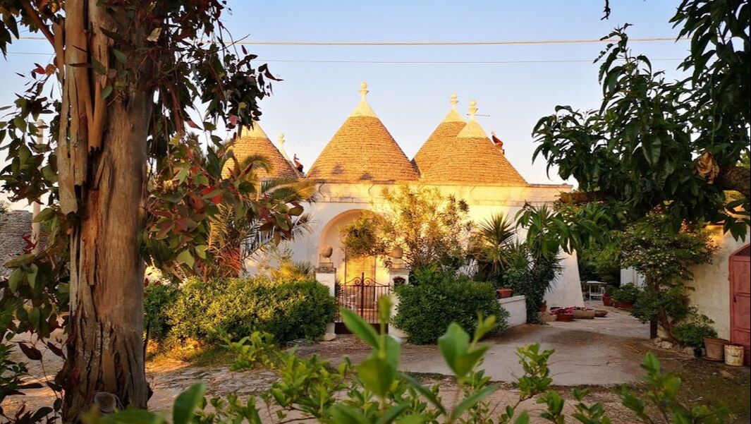 Typical set of trulli in puglia, italy bathed in the setting sunlight