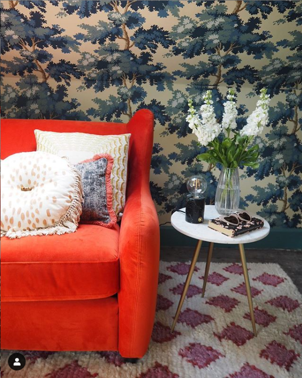 Sandra has used the Raphaël dark blue wallpaper as a beautiful back drop to this gorgeous burnt orange sofa bed by Made.com